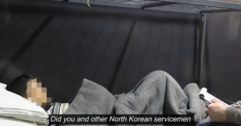 Ukraine President Volodymr Zelenskyy says this image made from a video he released shows a North Korean soldier captured by Ukraine in Kursk. Part of the image has been blurred by RFA.