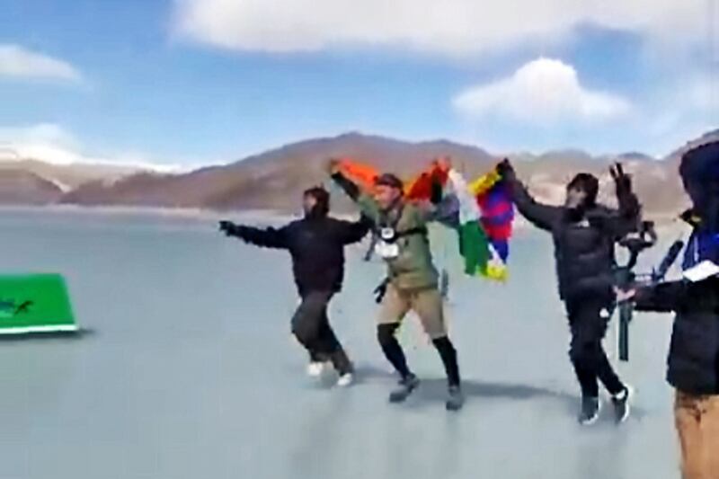 Tibetan runner Lobsang Tharchin, center, approaches the finish line of the Pangong Frozen Lake Marathon, on the India-TIbet border, Feb. 25, 2025. Image from video.