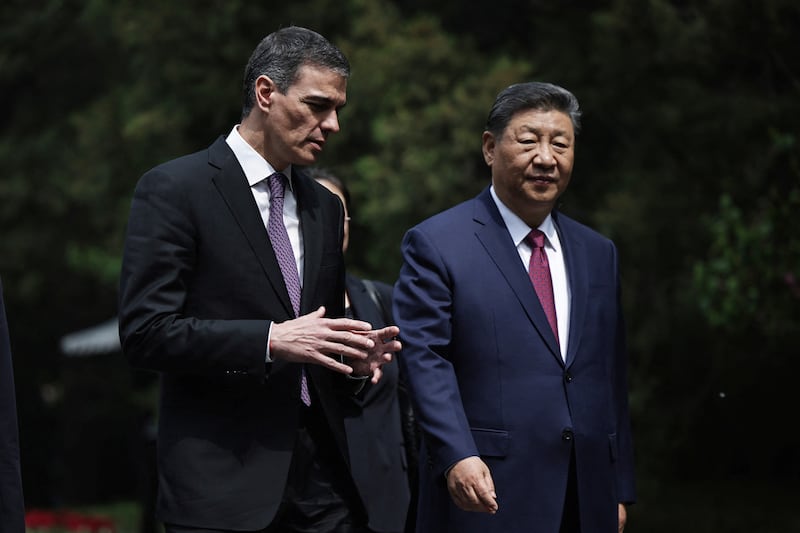 Spanish Prime Minister Pedro Sanchez and Chinese President Xi Jinping speak as they walk along the gardens of Diaoyutai Guest House after a meeting in Beijing, China, 11 April 2025. ANDRES MARTINEZ CASARES/Pool via REUTERS